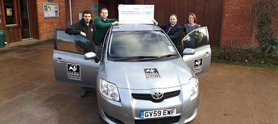 Team members with an Auris from the trust’s fleet. 