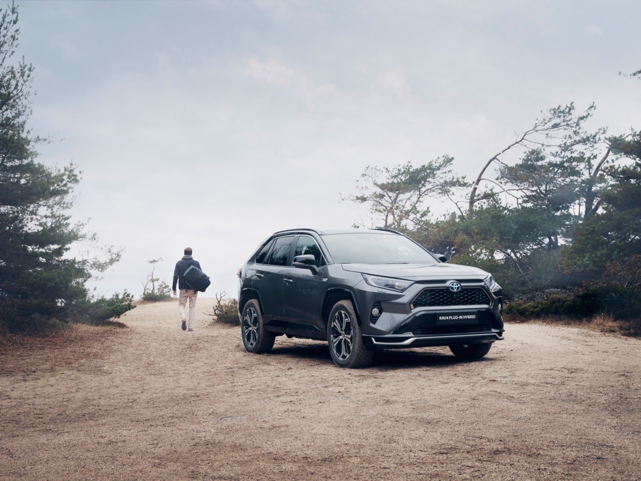 Man outdoors walking away from his RAV4