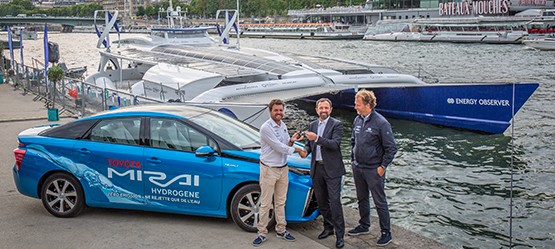 Three men and a car next to a boat