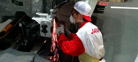 A worker repairing the car body